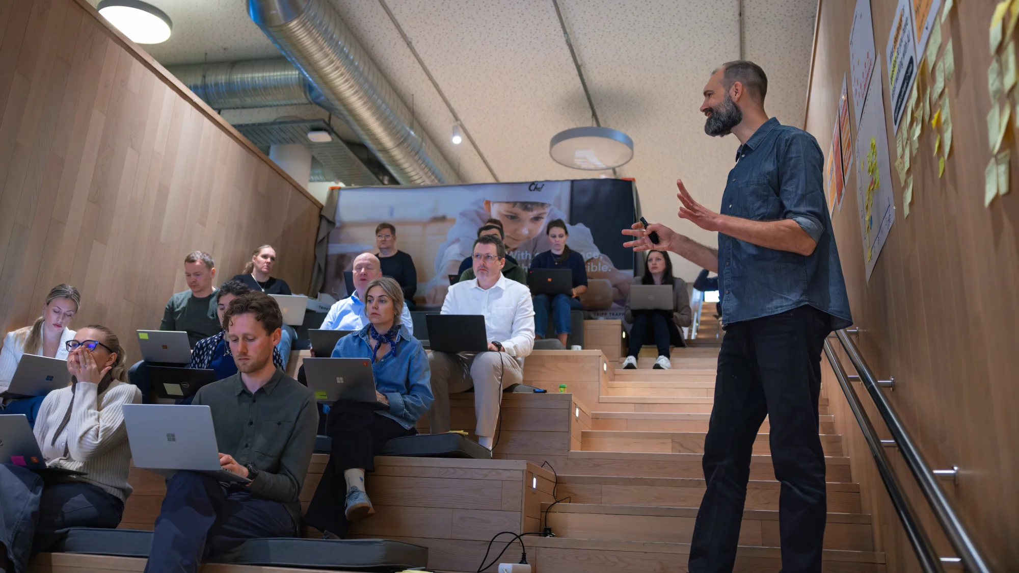 Wijde shot van een trainingsgroep met laptops op de tribune